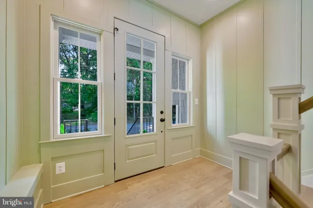 a view of a dining room and livingroom with furniture wooden floor a chandelier