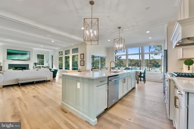 a kitchen with stainless steel appliances granite countertop a dining table chairs and granite counter tops