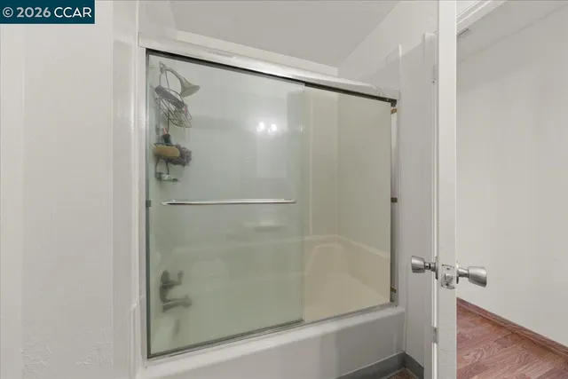 a bathroom with a glass shower door