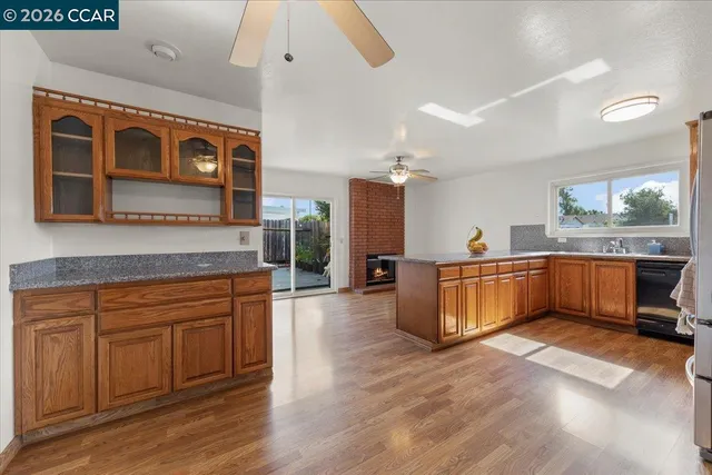 a large kitchen with stainless steel appliances wooden floors and wooden cabinets