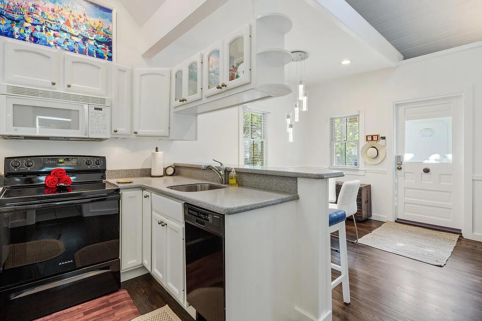 817 Terry Lane Key West, FL 33040 - Photo 20 of 20 a kitchen with granite countertop a sink stainless steel appliances and cabinets