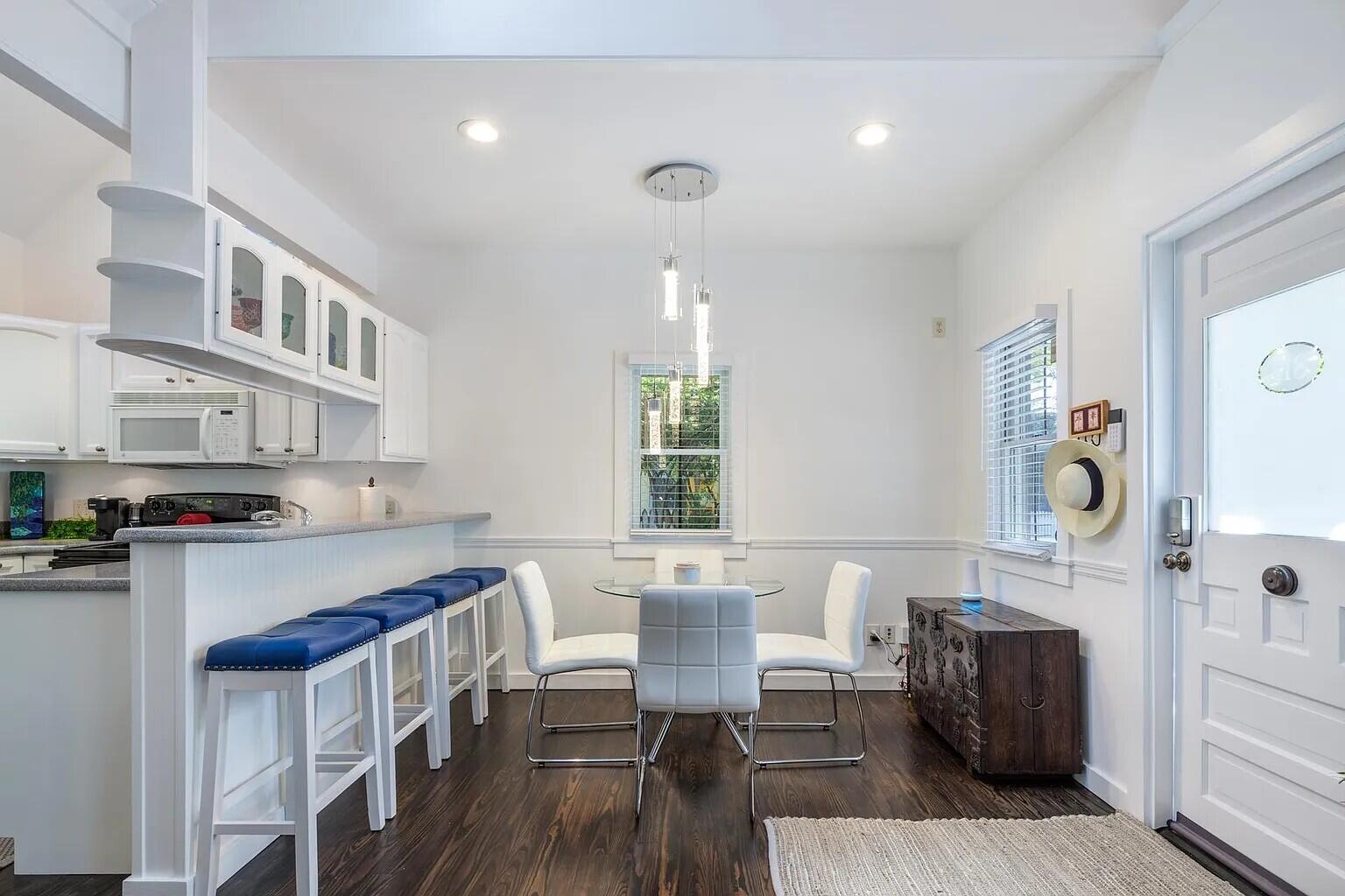 817 Terry Lane Key West, FL 33040 - Photo 11 of 20 a kitchen with a table chairs and a refrigerator