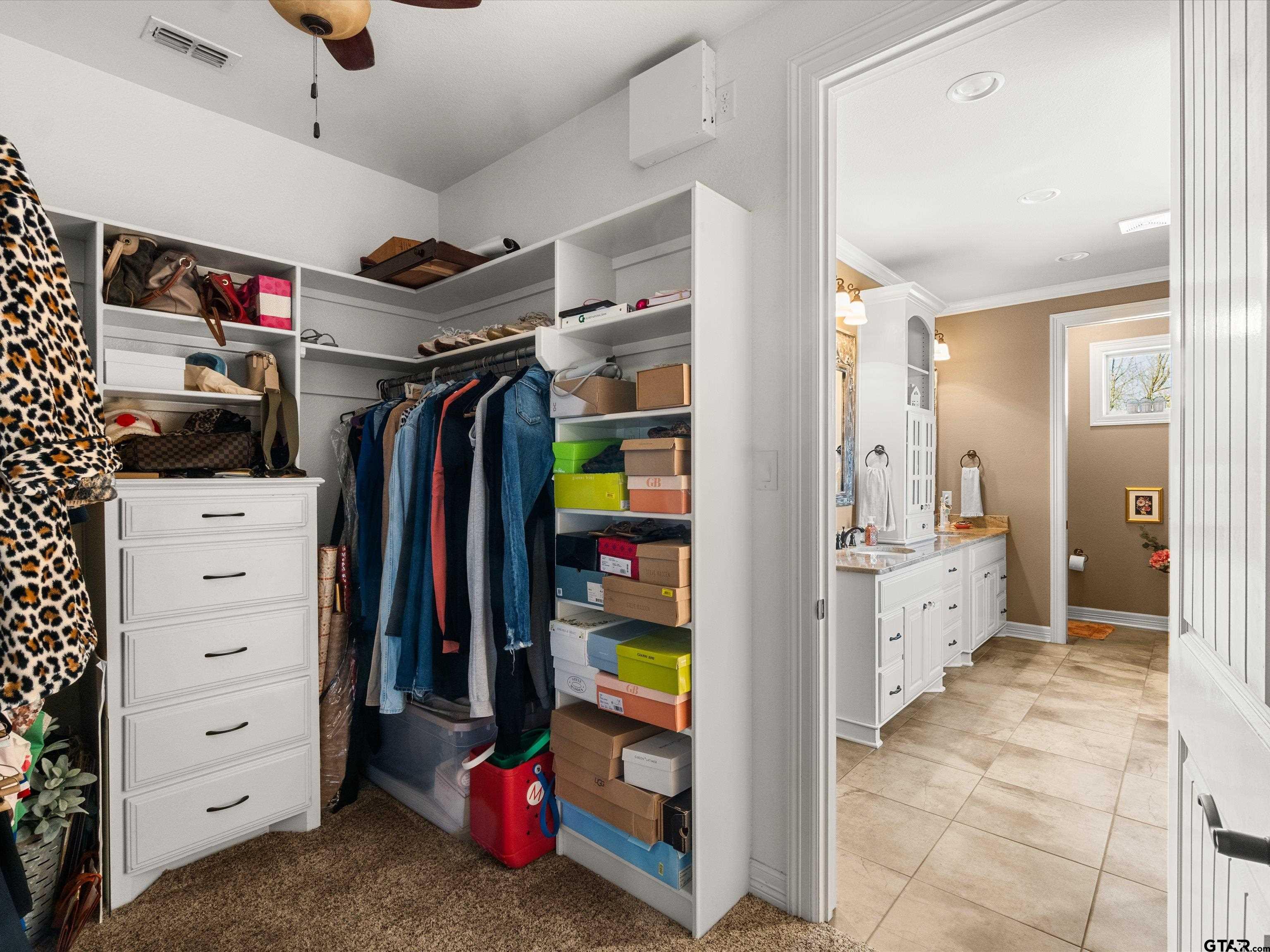 11087 Wolverine Road Pittsburg, TX 75686 - Photo 21 of 39 a view of walk in closet with clothes and shoes