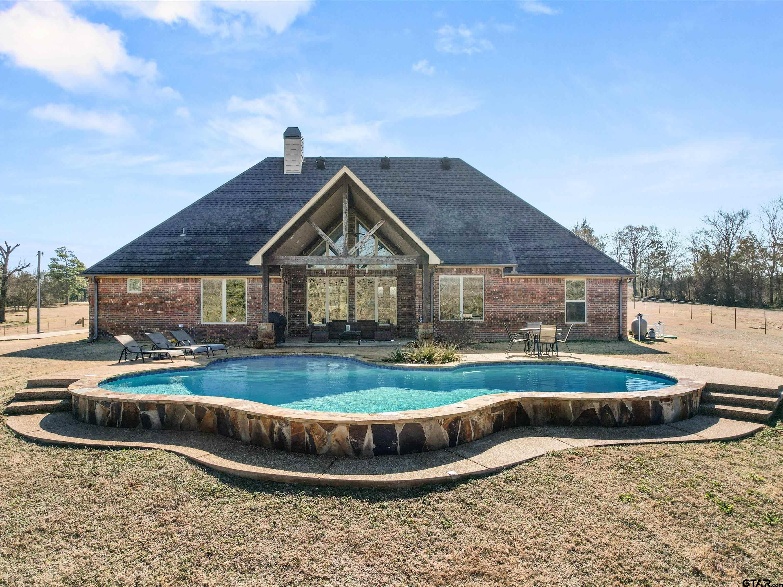 11087 Wolverine Road Pittsburg, TX 75686 - Photo 25 of 39 a front view of a house with garden