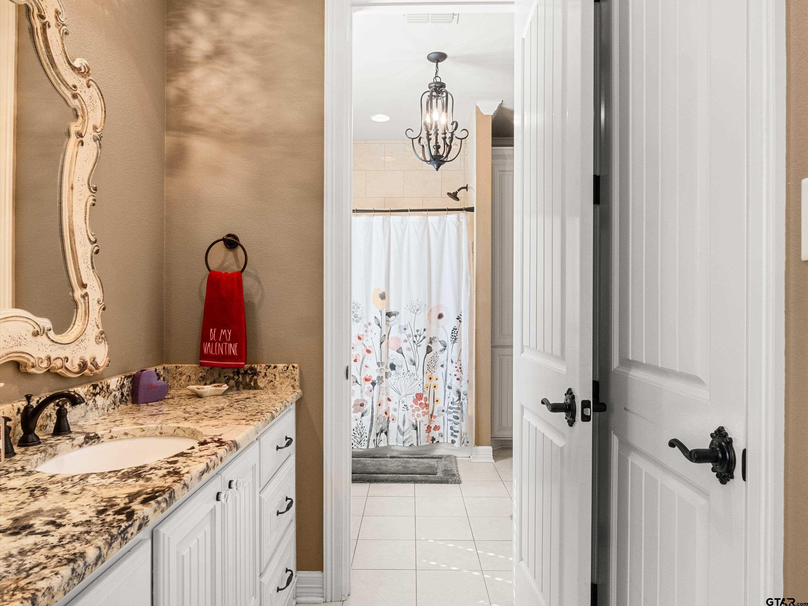 11087 Wolverine Road Pittsburg, TX 75686 - Photo 28 of 39 a bathroom with a granite countertop sink and a mirror