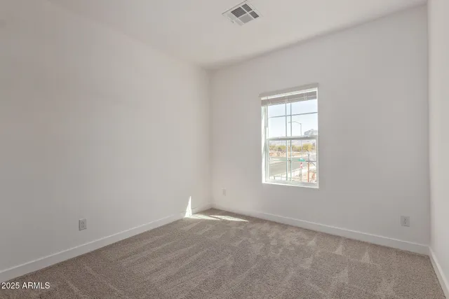 a view of an empty room and closet area