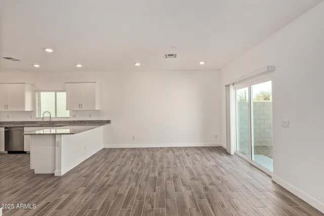 a large kitchen with stainless steel appliances granite countertop a large counter top and a stove top oven