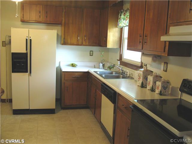 11300 Celtic Road Chesterfield, VA 23838 - Photo 11 of 12 a kitchen with a sink refrigerator and cabinets