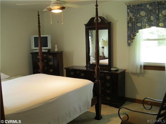 11300 Celtic Road Chesterfield, VA 23838 - Photo 12 of 12 a bedroom with a bed and a mirror