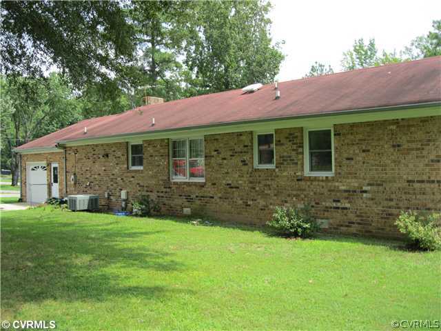 11300 Celtic Road Chesterfield, VA 23838 - Photo 5 of 12 a front view of a house with a garden