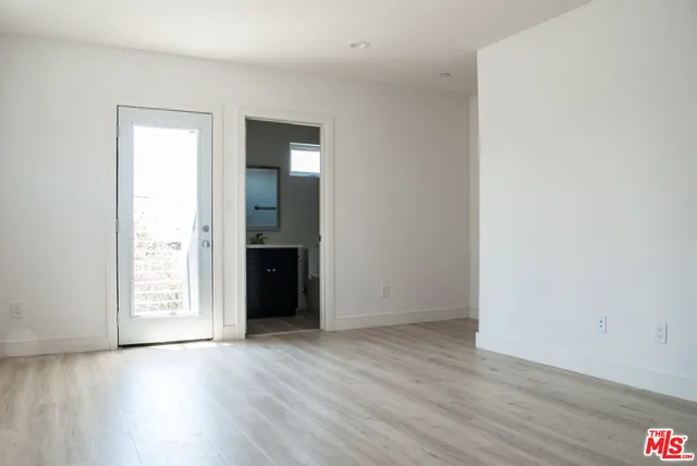 an empty room with wooden floor and closet