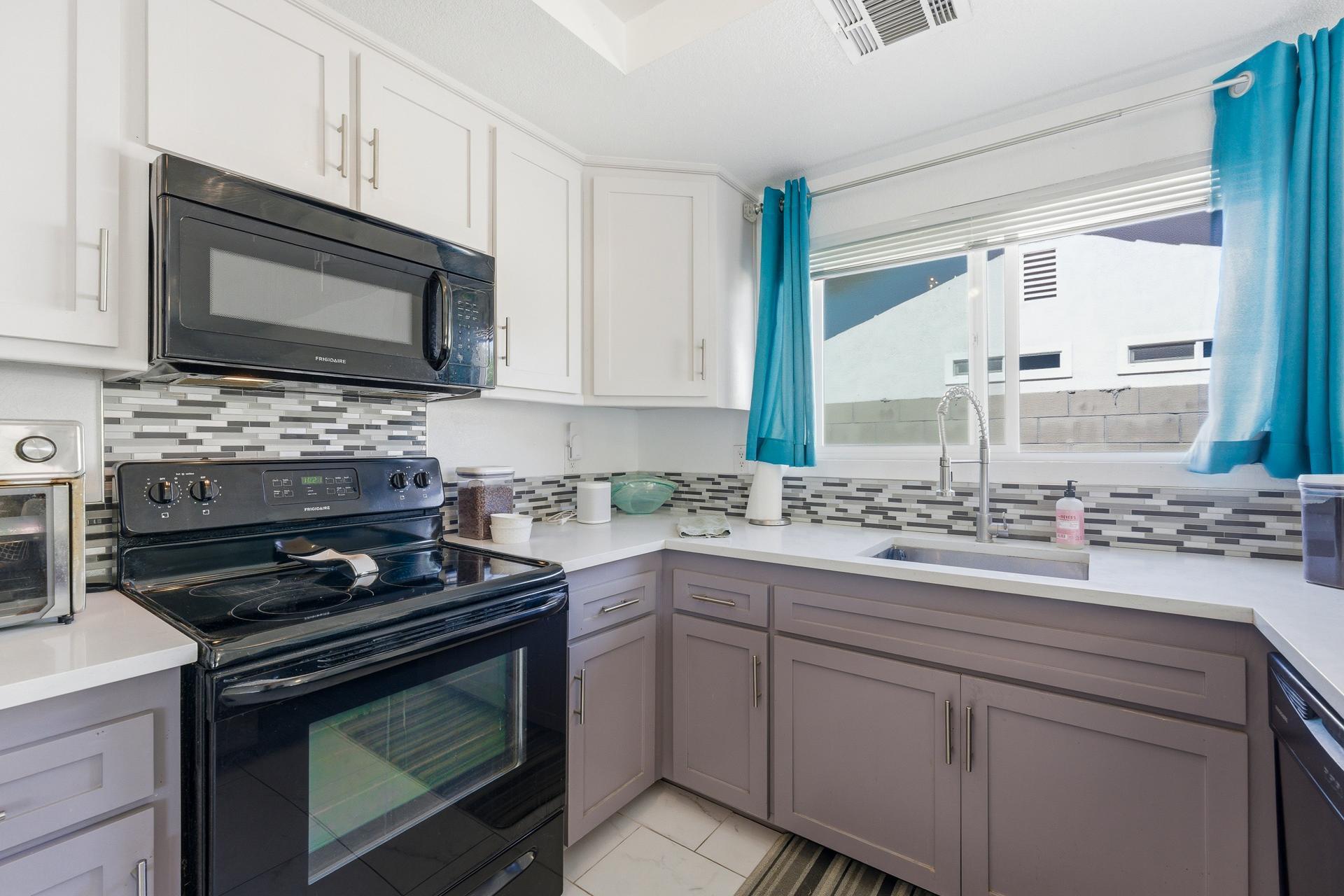 67220 Quijo Road Cathedral City, CA 92234 - Photo 9 of 26 a kitchen with cabinets appliances and a sink