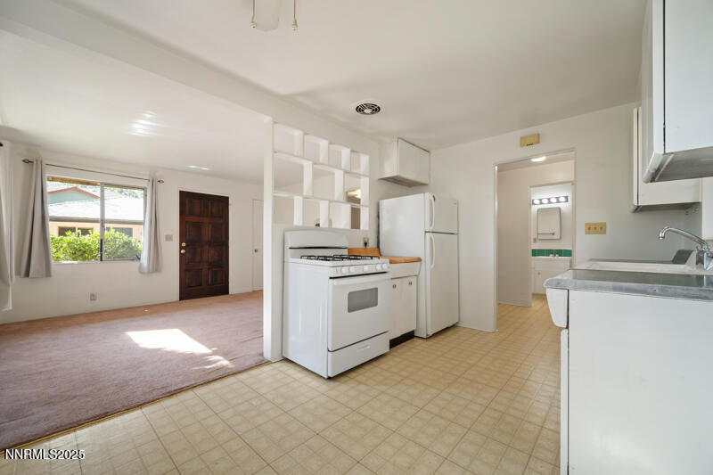 1245 Plumas Street Reno, NV 89509 - Photo 6 of 16 a kitchen with stainless steel appliances kitchen island granite countertop a stove a sink and a refrigerator