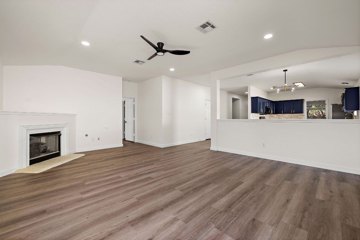 3219 Arroyo Bluff Lane Round Rock, TX 78681 - Photo 13 of 27 an empty room with wooden floor fireplace and windows