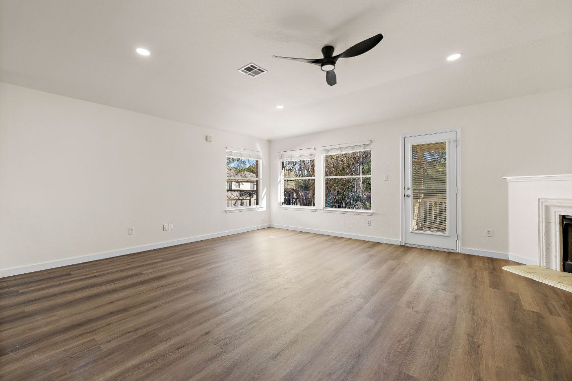 3219 Arroyo Bluff Lane Round Rock, TX 78681 - Photo 14 of 27 a view of an empty room with a window and wooden floor