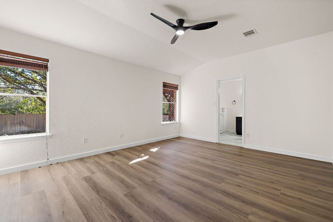3219 Arroyo Bluff Lane Round Rock, TX 78681 - Photo 17 of 27 a view of an empty room with wooden floor and a window