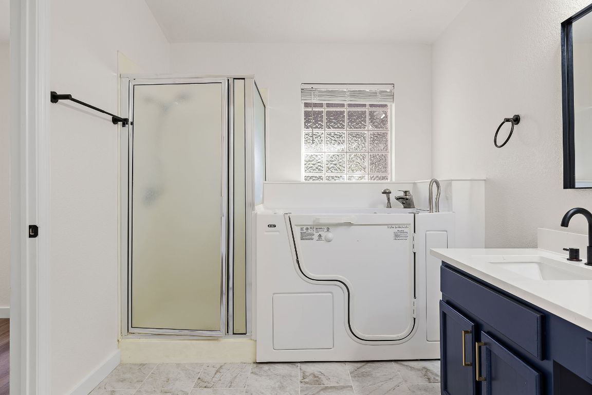 3219 Arroyo Bluff Lane Round Rock, TX 78681 - Photo 18 of 27 a bathroom with a granite countertop shower and a sink