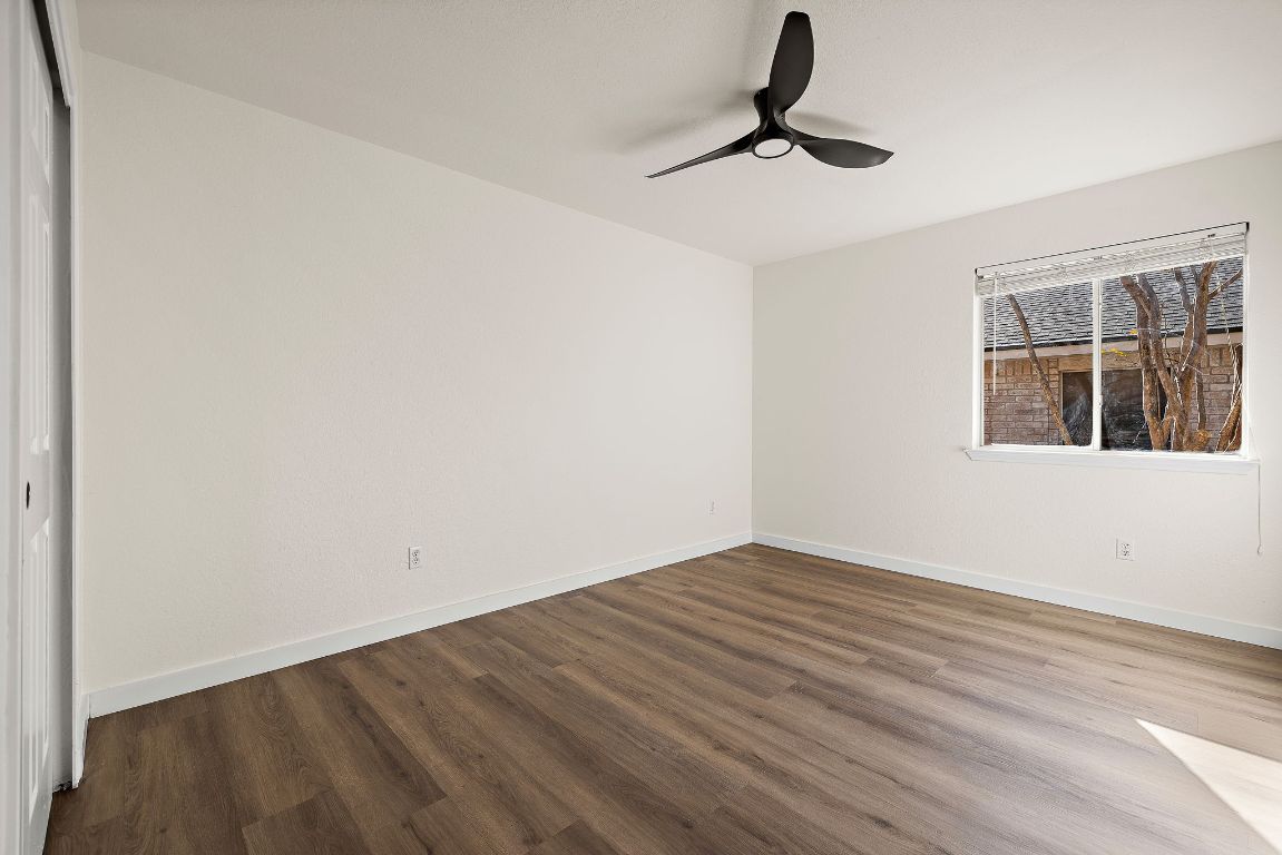 3219 Arroyo Bluff Lane Round Rock, TX 78681 - Photo 20 of 27 a view of an empty room with chandelier fan and wooden floor