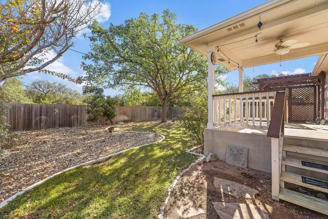 a view of a house with backyard and tree