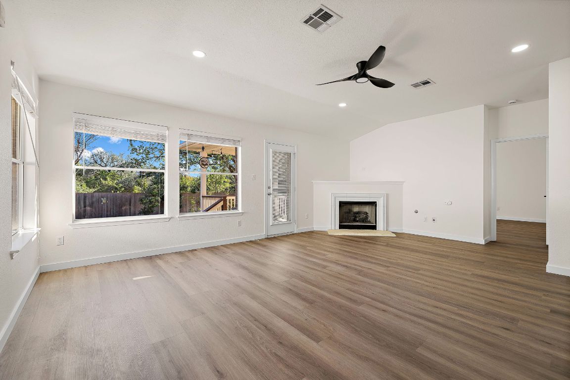 3219 Arroyo Bluff Lane Round Rock, TX 78681 - Photo 3 of 27 a view of an empty room with a window and wooden floor