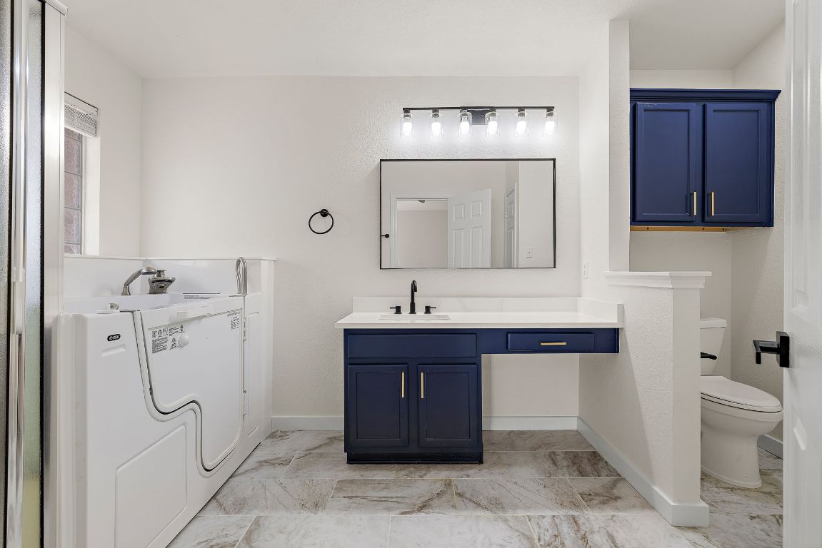 3219 Arroyo Bluff Lane Round Rock, TX 78681 - Photo 4 of 27 a bathroom with a sink a toilet and shower