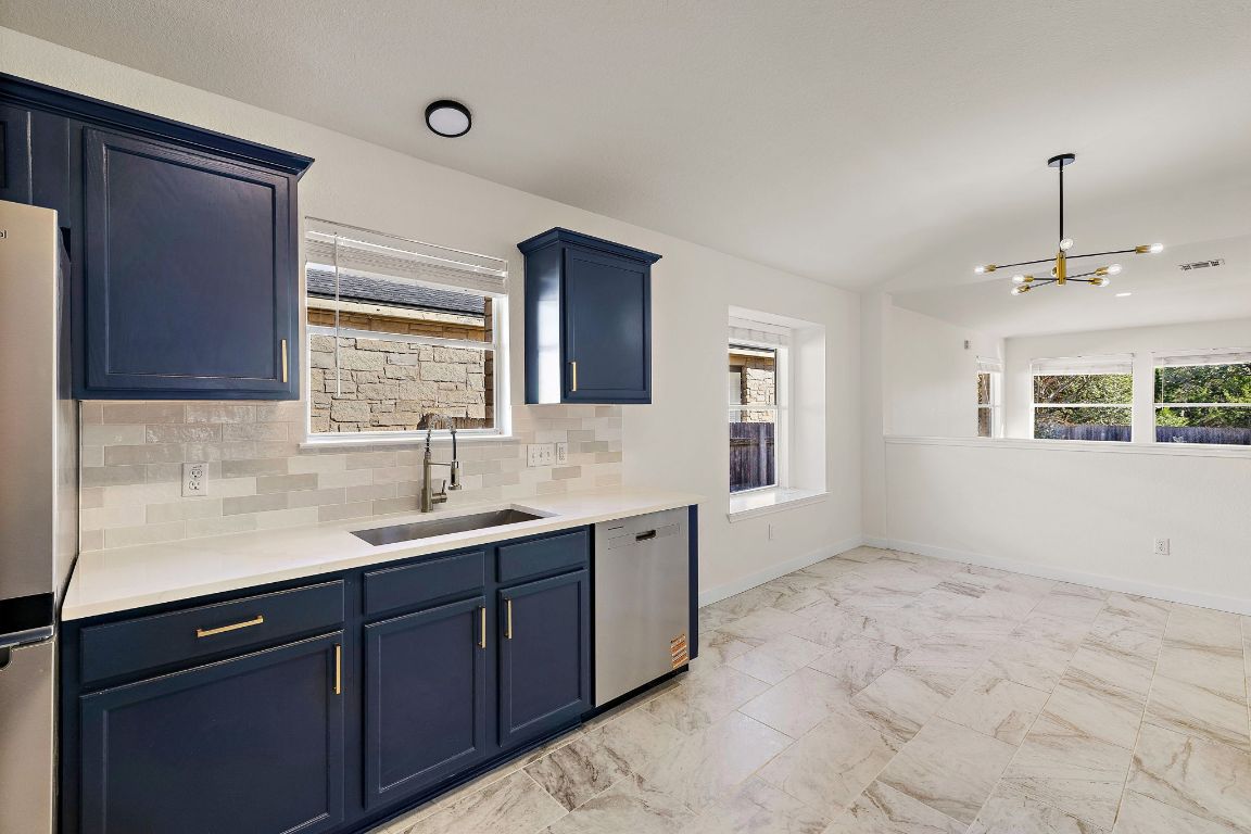 3219 Arroyo Bluff Lane Round Rock, TX 78681 - Photo 8 of 27 a kitchen with a sink stove and cabinets