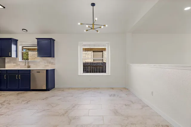 a view of a kitchen with a sink and cabinet