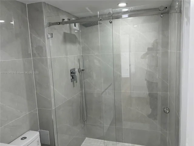 a bathroom with a toilet and a shower