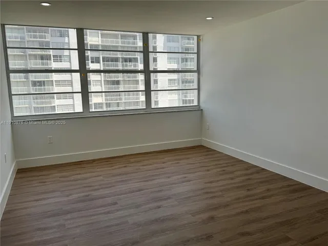 a view of hallway with sink and wooden floor