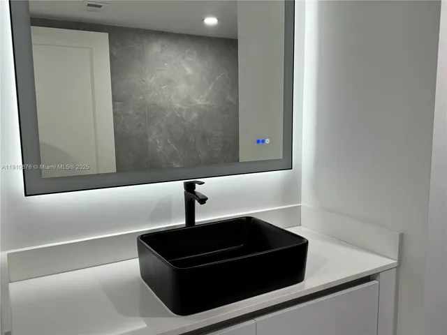 a white toilet sitting next to a shower