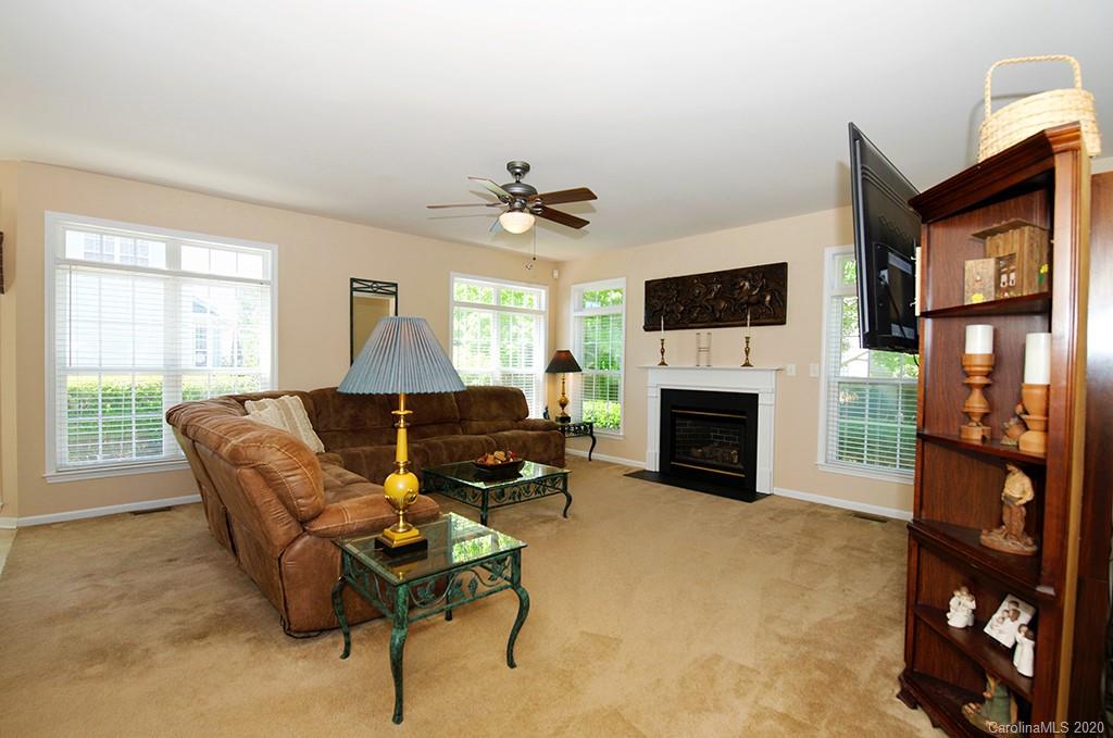 4322 Sunset Rose Drive Fort Mill, SC 29708 - Photo 11 of 34 a living room with furniture a fireplace and a flat screen tv