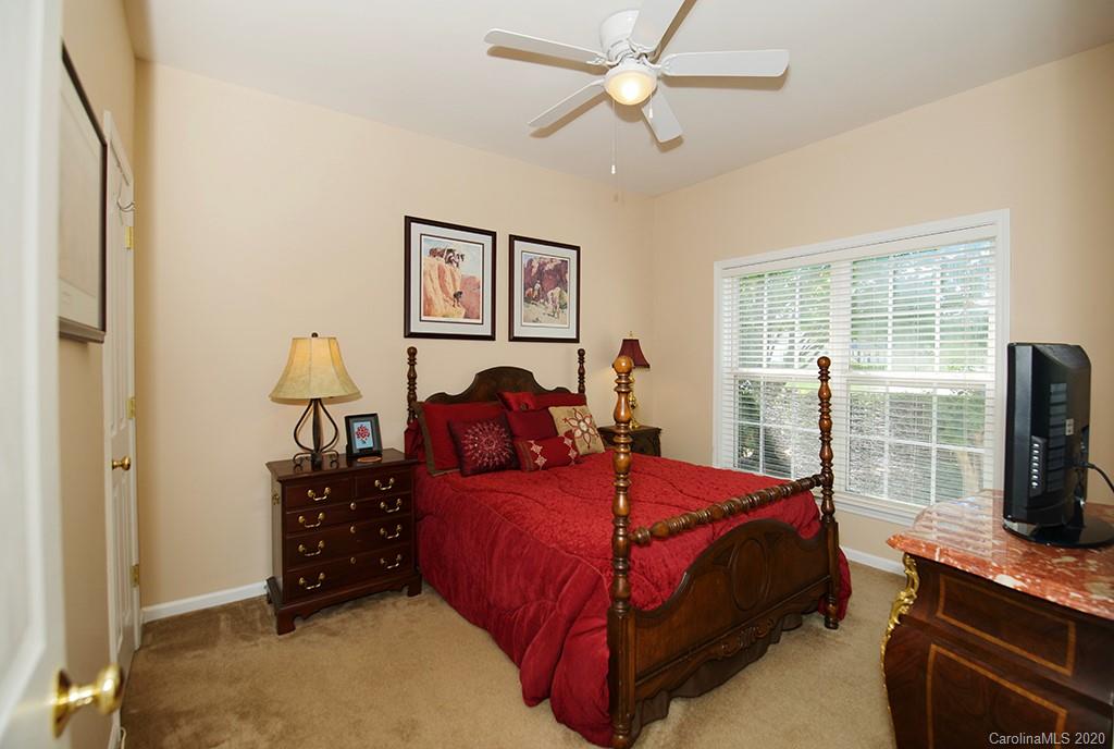 4322 Sunset Rose Drive Fort Mill, SC 29708 - Photo 15 of 34 a bedroom with a bed dresser and a flat tv screen