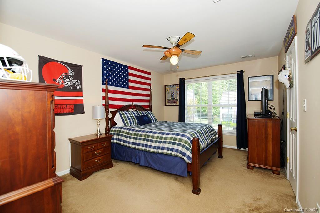 4322 Sunset Rose Drive Fort Mill, SC 29708 - Photo 17 of 34 a bedroom with a bed and a chandelier