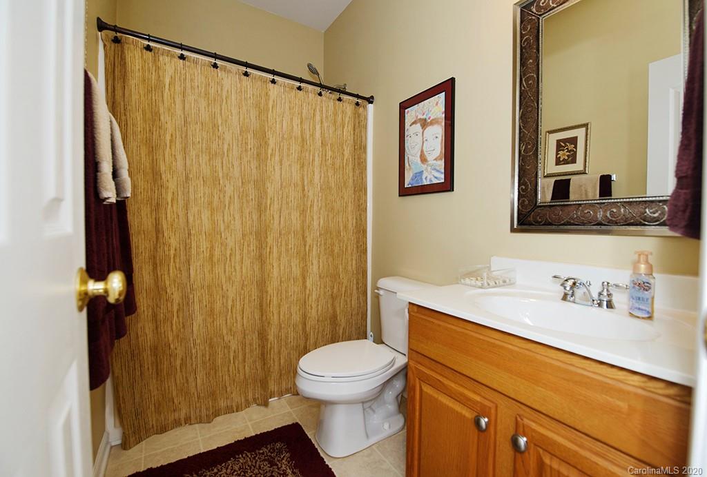 4322 Sunset Rose Drive Fort Mill, SC 29708 - Photo 18 of 34 a bathroom with a sink a toilet and shower curtain