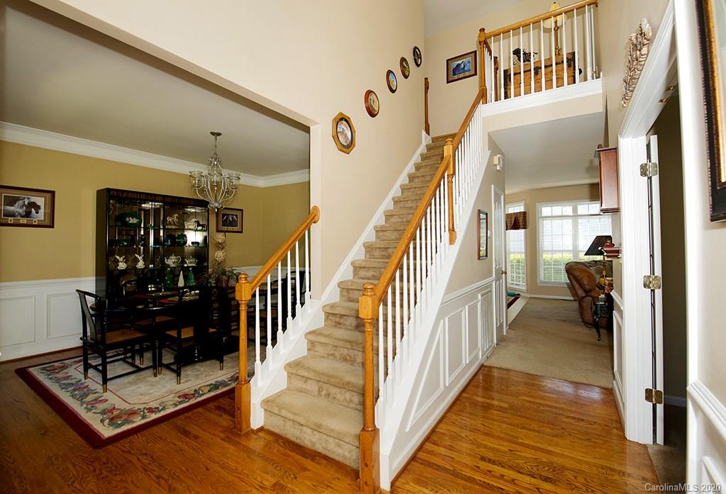 4322 Sunset Rose Drive Fort Mill, SC 29708 - Photo 3 of 34 a view of staircase with lots of frames on wall and a rug