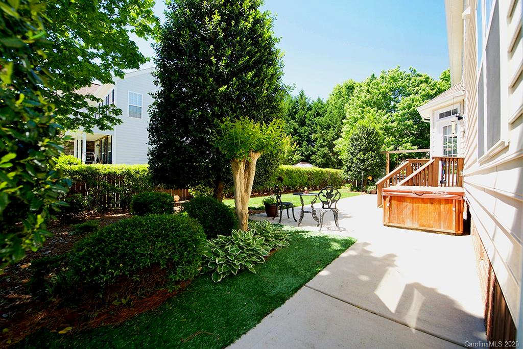 4322 Sunset Rose Drive Fort Mill, SC 29708 - Photo 26 of 34 a view of a backyard with table and chairs potted plants and large tree