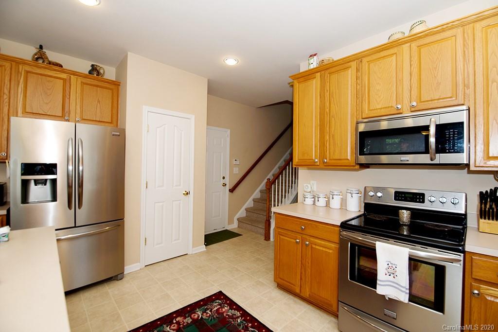 4322 Sunset Rose Drive Fort Mill, SC 29708 - Photo 8 of 34 a kitchen with stainless steel appliances a stove a microwave and a refrigerator