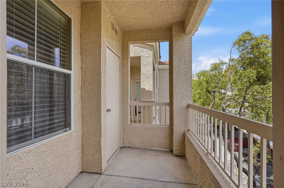 10550 West Alexander Road, Unit 2177 Las Vegas, NV 89129 - Photo 10 of 19 Enjoy outdoor living on this inviting private balcony with a view of mature trees.
