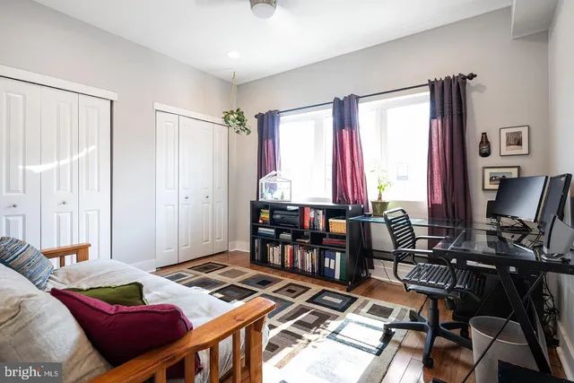 a living room with furniture a rug and a bookshelf