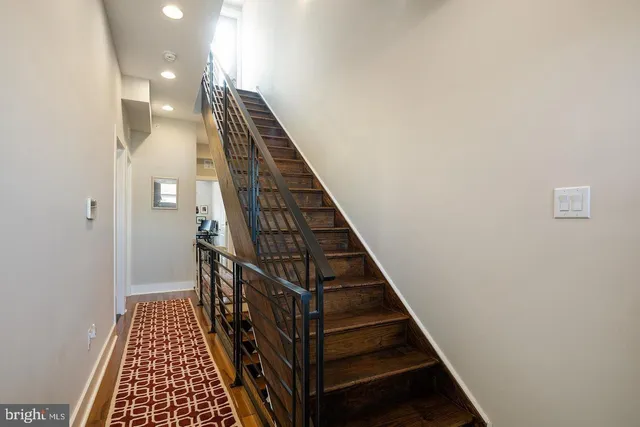 an outdoor sitting area with furniture and umbrella