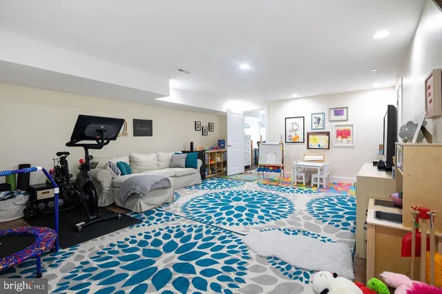 a bedroom with a bed and a lamp on dresser