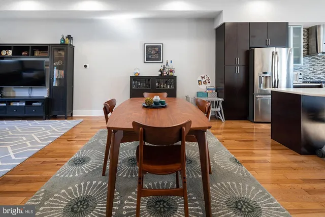 a dining room with a table and chairs