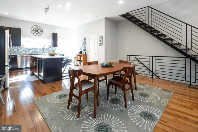 a dining room with furniture a rug and wooden floor