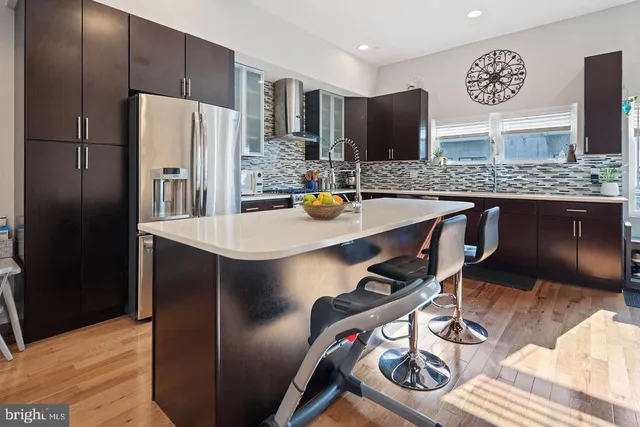 a kitchen with stainless steel appliances granite countertop a sink refrigerator and microwave