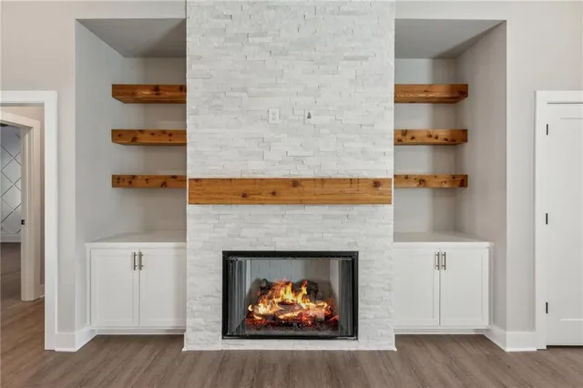 a room with a fireplace and cabinets