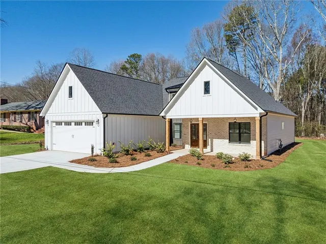 a front view of a house with garden