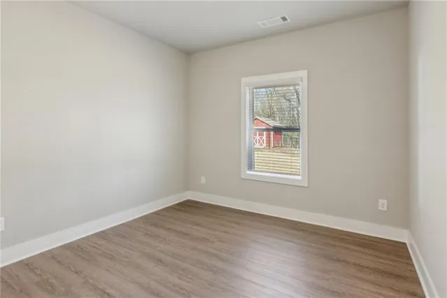wooden floor in an empty room with a window