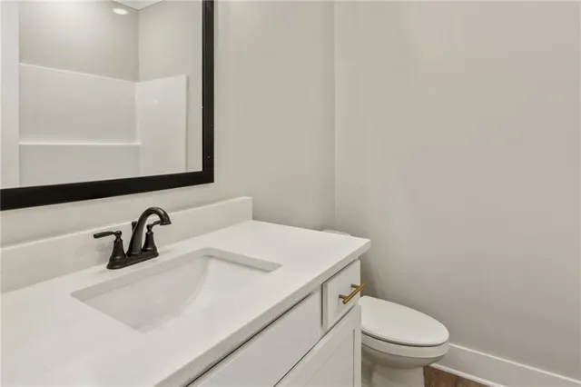 a bathroom with a sink a toilet and mirror