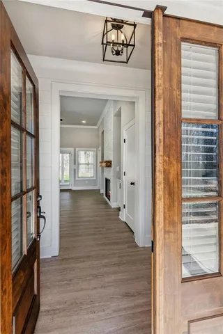 a view of an entryway with wooden floor