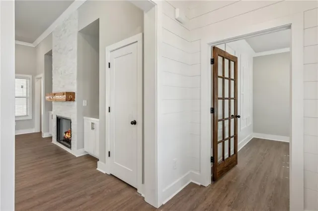 a view of a hallway with wooden floor and a fireplace